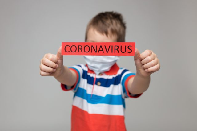 Young child wearing a respiratory mask as a prevention against the Coronavirus Covid-19